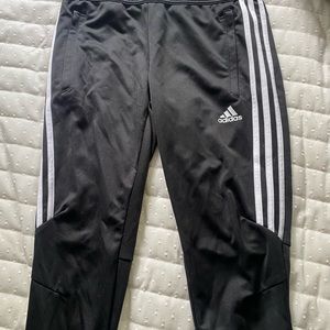 Adidas sweatpants with zipper bottoms.